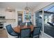 Elegant dining area with a wood table, patterned chairs, and sliding glass doors leading to outdoor space at 14718 San Domingo Blvd, Port Charlotte, FL 33981