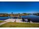 Private dock with boat lift and waterfront seating area under blue sky at 14718 San Domingo Blvd, Port Charlotte, FL 33981