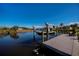 Dock with boat lift and waterfront seating area under blue sky at 14718 San Domingo Blvd, Port Charlotte, FL 33981