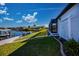 Exterior of home with waterfront views, screened in patio and lush lawn at 14718 San Domingo Blvd, Port Charlotte, FL 33981