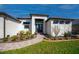 Welcoming front entry features a brick walkway, beautiful landscaping, and a modern double-door entrance at 14718 San Domingo Blvd, Port Charlotte, FL 33981
