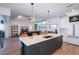 Kitchen island boasts a marble countertop, navy cabinets, and modern pendant lighting with open access to the living area at 14718 San Domingo Blvd, Port Charlotte, FL 33981