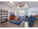 Inviting living room with a large TV, comfortable seating, stylish decor, and wood-look tile flooring at 14718 San Domingo Blvd, Port Charlotte, FL 33981