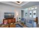Bright living room boasts an open layout, stylish furniture, and a large window that fills the space with light at 14718 San Domingo Blvd, Port Charlotte, FL 33981