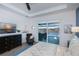 Well-appointed main bedroom with ceiling fan, king bed, ensuite bath access, pool view, and wood-style floors at 14718 San Domingo Blvd, Port Charlotte, FL 33981