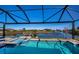Stunning pool and canal view from the lanai, perfect for relaxation and entertaining at 14718 San Domingo Blvd, Port Charlotte, FL 33981