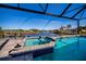 Screened pool and spa with mosaic tile trim and water view at 14718 San Domingo Blvd, Port Charlotte, FL 33981