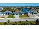 Newly constructed modern home boasting a spacious three-car garage and beautiful landscaping enhancing curb appeal at 14718 San Domingo Blvd, Port Charlotte, FL 33981