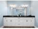 Spacious bathroom with a double vanity, granite countertop, and ample storage space at 15044 Acorn Cir, Port Charlotte, FL 33981