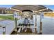 Boat lift and dock on canal with clear water views and cover overhead at 15044 Acorn Cir, Port Charlotte, FL 33981