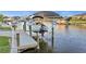 A boat lift and dock on a canal provides convenience for boaters at 15044 Acorn Cir, Port Charlotte, FL 33981