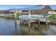 Canal-side boat lift offers convenient access for boating enthusiasts at 15044 Acorn Cir, Port Charlotte, FL 33981