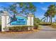 South Gulf Cove community entrance sign with lush landscaping and a clear blue sky in the background at 15044 Acorn Cir, Port Charlotte, FL 33981