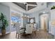 Charming dining area featuring a wooden table, elegant chandelier, and sliding glass doors to the outdoor patio at 15044 Acorn Cir, Port Charlotte, FL 33981