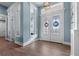 Bright foyer features wood-look tile floors and decorative glass double doors at 15044 Acorn Cir, Port Charlotte, FL 33981