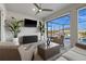 Covered lanai features comfortable wicker seating, a ceiling fan, and a view of the screened pool at 15044 Acorn Cir, Port Charlotte, FL 33981