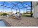 Screened in lanai showcases an outdoor lounge area with a grill and a stunning waterfront view at 15044 Acorn Cir, Port Charlotte, FL 33981