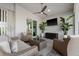 Covered lanai features comfortable wicker seating, a ceiling fan, and a view of the Primary suite at 15044 Acorn Cir, Port Charlotte, FL 33981