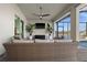 Covered lanai features comfortable wicker seating, a ceiling fan, and a beautiful view of the waterfront at 15044 Acorn Cir, Port Charlotte, FL 33981