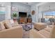 Comfortable living room with neutral decor, stylish furniture, and sliding glass doors at 15044 Acorn Cir, Port Charlotte, FL 33981