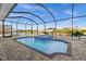Screened in lanai showcases a pool, spa, and a beautiful waterfront view at 15044 Acorn Cir, Port Charlotte, FL 33981