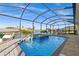 Screened in lanai showcases a pool, spa, and a beautiful waterfront view at 15044 Acorn Cir, Port Charlotte, FL 33981