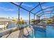 Inviting screened-in pool and spa with waterfront views at 15044 Acorn Cir, Port Charlotte, FL 33981