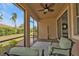 Screened lanai with outdoor seating, brick flooring, and a beautiful backyard view at 152 Ventosa Pl, Nokomis, FL 34275