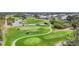 Picturesque golf course community featuring water features, winding paths, and lush green landscapes under a clear sky at 16 Windward Ter, Placida, FL 33946
