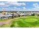 Golf course community view featuring lush green spaces and beautiful single-Gathering homes under a bright, cloudy sky at 16 Windward Ter, Placida, FL 33946