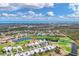 Expansive aerial view of a golf course community showcasing lovely homes, scenic waterways, and lush landscaping at 16 Windward Ter, Placida, FL 33946