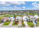 Aerial view of a well-maintained home near a golf course and a scenic lake, surrounded by lush greenery at 16 Windward Ter, Placida, FL 33946