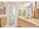 Cozy bathroom with a well-lit vanity and artwork, adjacent to a separate toilet room at 16 Windward Ter, Placida, FL 33946