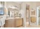 Well-lit bathroom featuring a spacious vanity, and tiled floors, leading to the shower at 16 Windward Ter, Placida, FL 33946