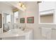 Bright bathroom features framed art, white vanity, and a large mirror above the sink at 16 Windward Ter, Placida, FL 33946