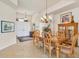 Elegant dining area featuring a chandelier, a decorative cabinet, and a view of the home's entrance at 16 Windward Ter, Placida, FL 33946