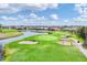 Scenic golf course featuring a pristine green, sand traps, and a serene lake surrounded by well-maintained grounds at 16 Windward Ter, Placida, FL 33946