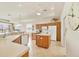 Bright kitchen featuring an island, tile floors, wooden cabinets, and modern white appliances at 16 Windward Ter, Placida, FL 33946