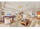 Open-concept living area with tile flooring, comfortable seating, a ceiling fan, and views of the kitchen and dining area at 16 Windward Ter, Placida, FL 33946