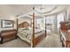 Elegant main bedroom with a canopy bed, tray ceilings, and large windows providing a serene retreat at 16 Windward Ter, Placida, FL 33946