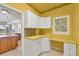 Bright office space featuring a white built-in desk and cabinetry, adjoining the kitchen at 16 Windward Ter, Placida, FL 33946