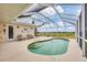 Screened-in patio with large kidney-shaped pool, surrounded by green lawns and golf course views at 16 Windward Ter, Placida, FL 33946