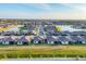 Aerial view of a new home community featuring houses around a scenic lake at 1602 Saddlewood Cir, Port Charlotte, FL 33953
