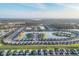 Panoramic aerial view of a Primary-planned community featuring lush landscaping and waterfront homes at 1602 Saddlewood Cir, Port Charlotte, FL 33953