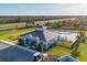 Aerial view of the community pool and clubhouse with ample seating and lush landscaping at 1602 Saddlewood Cir, Port Charlotte, FL 33953
