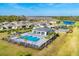 Aerial shot of the community pool with a gazebo and plentiful seating surrounded by palm trees at 1602 Saddlewood Cir, Port Charlotte, FL 33953