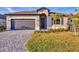 Charming single-story home with a gray garage door, walkway, and freshly cut green grass at 1602 Saddlewood Cir, Port Charlotte, FL 33953