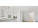 Modern white kitchen with stainless steel appliances, granite countertops, and a breakfast bar at 1602 Saddlewood Cir, Port Charlotte, FL 33953