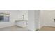 Open-concept kitchen with white cabinets, granite countertops, and stainless steel appliances at 1602 Saddlewood Cir, Port Charlotte, FL 33953