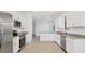 Bright kitchen features stainless steel appliances, granite countertops, and white cabinets at 1602 Saddlewood Cir, Port Charlotte, FL 33953